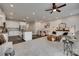 Open-concept living space with kitchen, dining area, and comfortable seating on light carpet at 318 Willow Wood Ct, Matthews, NC 28104
