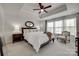 Spacious main bedroom featuring tray ceiling, plush carpet, and large windows with natural light at 318 Willow Wood Ct, Matthews, NC 28104