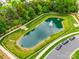 Aerial view of a tranquil pond with fountain, enhancing the community's landscape at 318 Willow Wood Ct, Matthews, NC 28104