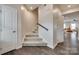 Bright entryway featuring a staircase with wood railing and gray wood-look floors at 318 Willow Wood Ct, Matthews, NC 28104