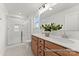 Bright bathroom showcasing double sinks, wood cabinetry, a shower, and a large mirror at 32612-B Millingport Rd # 7157, New London, NC 28127