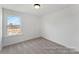 Bright bedroom features a window and plush neutral carpeting at 32612-B Millingport Rd # 7157, New London, NC 28127