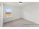 Bright and simple bedroom with a large window and neutral carpet at 32612-B Millingport Rd # 7157, New London, NC 28127
