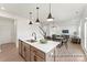 Bright, open-concept kitchen features a center island, stainless steel appliances, and modern pendant lighting at 32612-B Millingport Rd # 7157, New London, NC 28127