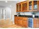 Wet bar area with wooden cabinetry, granite countertops, wine cooler, and stylish fixtures at 3324 Greenhurst Dr, Matthews, NC 28104