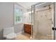 Bathroom features a glass-enclosed shower, single vanity, and neutral colored walls at 3324 Greenhurst Dr, Matthews, NC 28104