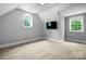 This bedroom features neutral walls, carpet, two windows and a TV at 3324 Greenhurst Dr, Matthews, NC 28104