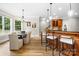 Charming dining area adjacent to a breakfast bar and featuring natural light and modern lighting fixtures at 3324 Greenhurst Dr, Matthews, NC 28104