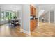 Open floor plan of the dining room featuring hardwood floors, chandelier and a wet bar with wine cooler at 3324 Greenhurst Dr, Matthews, NC 28104