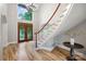 Bright foyer featuring curved staircase with hardwood floors and large windows with decorative glass at front door at 3324 Greenhurst Dr, Matthews, NC 28104