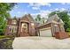 A grand two-story red brick home featuring a manicured lawn, a two car garage, and a concrete driveway at 3324 Greenhurst Dr, Matthews, NC 28104