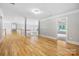 Upstairs hallway featuring hardwood flooring and open access to rooms, providing a spacious and airy feel at 3324 Greenhurst Dr, Matthews, NC 28104