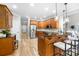 Spacious kitchen featuring hardwood flooring, a breakfast bar, and modern appliances at 3324 Greenhurst Dr, Matthews, NC 28104
