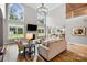 Open-concept living room featuring a fireplace, TV, high ceilings and lots of natural light at 3324 Greenhurst Dr, Matthews, NC 28104