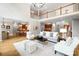Open floor plan with living room and wet bar featuring hardwood floors, modern lighting fixture, and neutral decor at 3324 Greenhurst Dr, Matthews, NC 28104