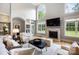 Bright living room with fireplace, large windows, and comfortable seating at 3324 Greenhurst Dr, Matthews, NC 28104