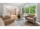 Bright living room showcasing large arched windows, comfortable seating, and elegant decor at 3324 Greenhurst Dr, Matthews, NC 28104