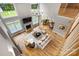 Open-concept living room featuring hardwood floors, a fireplace, large windows, and neutral decor for comfortable living at 3324 Greenhurst Dr, Matthews, NC 28104