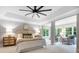 A spacious main bedroom features a seating area, neutral colors, and a modern ceiling fan at 3324 Greenhurst Dr, Matthews, NC 28104