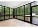 The screened-in porch with brick pillars offers views of the wooded backyard at 3324 Greenhurst Dr, Matthews, NC 28104