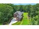 Expansive brick home surrounded by lush greenery, showcasing the spacious lot and well-manicured lawn at 3324 Greenhurst Dr, Weddington, NC 28104