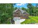 Stunning brick facade with a well-manicured lawn and curved driveway leading to a grand entrance at 3324 Greenhurst Dr, Weddington, NC 28104