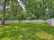 Large backyard featuring a well-manicured lawn, privacy fence and mature trees at 431 Wonderwood Dr, Charlotte, NC 28211