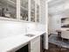 Chic bar area with marble countertop, glass cabinets, and a wine refrigerator at 431 Wonderwood Dr, Charlotte, NC 28211