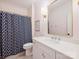 Charming bathroom with patterned shower curtain, marble countertop vanity, and stylish gold fixtures at 431 Wonderwood Dr, Charlotte, NC 28211