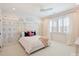 Cozy bedroom features a whimsical city skyline mural, plantation shutters, and a modern ceiling fan at 431 Wonderwood Dr, Charlotte, NC 28211