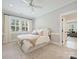Bright bedroom featuring white walls, large windows with shutters, and neutral-toned décor at 431 Wonderwood Dr, Charlotte, NC 28211