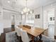 Inviting dining room showcasing coffered ceilings, stylish lighting, and a view of the kitchen at 431 Wonderwood Dr, Charlotte, NC 28211
