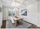 Elegant dining room with a modern light fixture, a large window, and a neutral color palette at 431 Wonderwood Dr, Charlotte, NC 28211