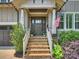 Inviting front entrance featuring stone steps, a decorative door, and lush landscaping at 431 Wonderwood Dr, Charlotte, NC 28211