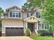 Charming two-story home with a craftsman style, manicured lawn, and a two-car garage at 431 Wonderwood Dr, Charlotte, NC 28211