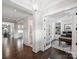 Spacious hallway featuring hardwood floors, a view into the office, and wainscoting at 431 Wonderwood Dr, Charlotte, NC 28211