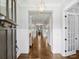 Elegant hallway with hardwood floors, wainscoting, and a view into the dining area at 431 Wonderwood Dr, Charlotte, NC 28211