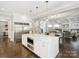 Stylish kitchen featuring a large island with marble countertop and stainless steel refrigerator at 431 Wonderwood Dr, Charlotte, NC 28211
