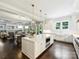 Open-concept kitchen with a large island, stainless steel appliances, and hardwood flooring at 431 Wonderwood Dr, Charlotte, NC 28211