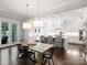 Open-concept kitchen and dining area with stainless steel appliances and modern pendant lighting at 431 Wonderwood Dr, Charlotte, NC 28211