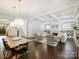 Spacious living and dining area with hardwood floors, coffered ceilings, and an open layout at 431 Wonderwood Dr, Charlotte, NC 28211