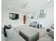 Large living room with gray sectional seating, a wall-mounted TV, and stylish decor at 431 Wonderwood Dr, Charlotte, NC 28211