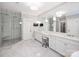 Spacious main bathroom with white marble floors, double vanity, frameless glass shower, and spa-like amenities at 431 Wonderwood Dr, Charlotte, NC 28211