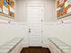 Traditional mudroom with built-in storage benches, hooks, and a white door offering both functionality and style at 431 Wonderwood Dr, Charlotte, NC 28211