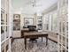 Bright office with built-in bookshelves, plantation shutters, and a classic desk at 431 Wonderwood Dr, Charlotte, NC 28211