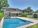 Large backyard pool surrounded by lush greenery and stone pavers near the home at 431 Wonderwood Dr, Charlotte, NC 28211