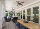 Spacious screened porch with a dining area and cozy seating, offering views of the outdoor greenery at 431 Wonderwood Dr, Charlotte, NC 28211