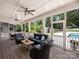 Relaxing screened porch with outdoor seating and dining, perfect for enjoying the pool and backyard at 431 Wonderwood Dr, Charlotte, NC 28211