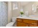Bathroom featuring a single vanity, a toilet, floral shower curtain, and a mirror at 44409 Oriole Dr # 200, Indian Land, SC 29707