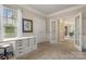 Bright bedroom features a built-in desk and doorway views of the hallway and dining room at 44409 Oriole Dr # 200, Indian Land, SC 29707